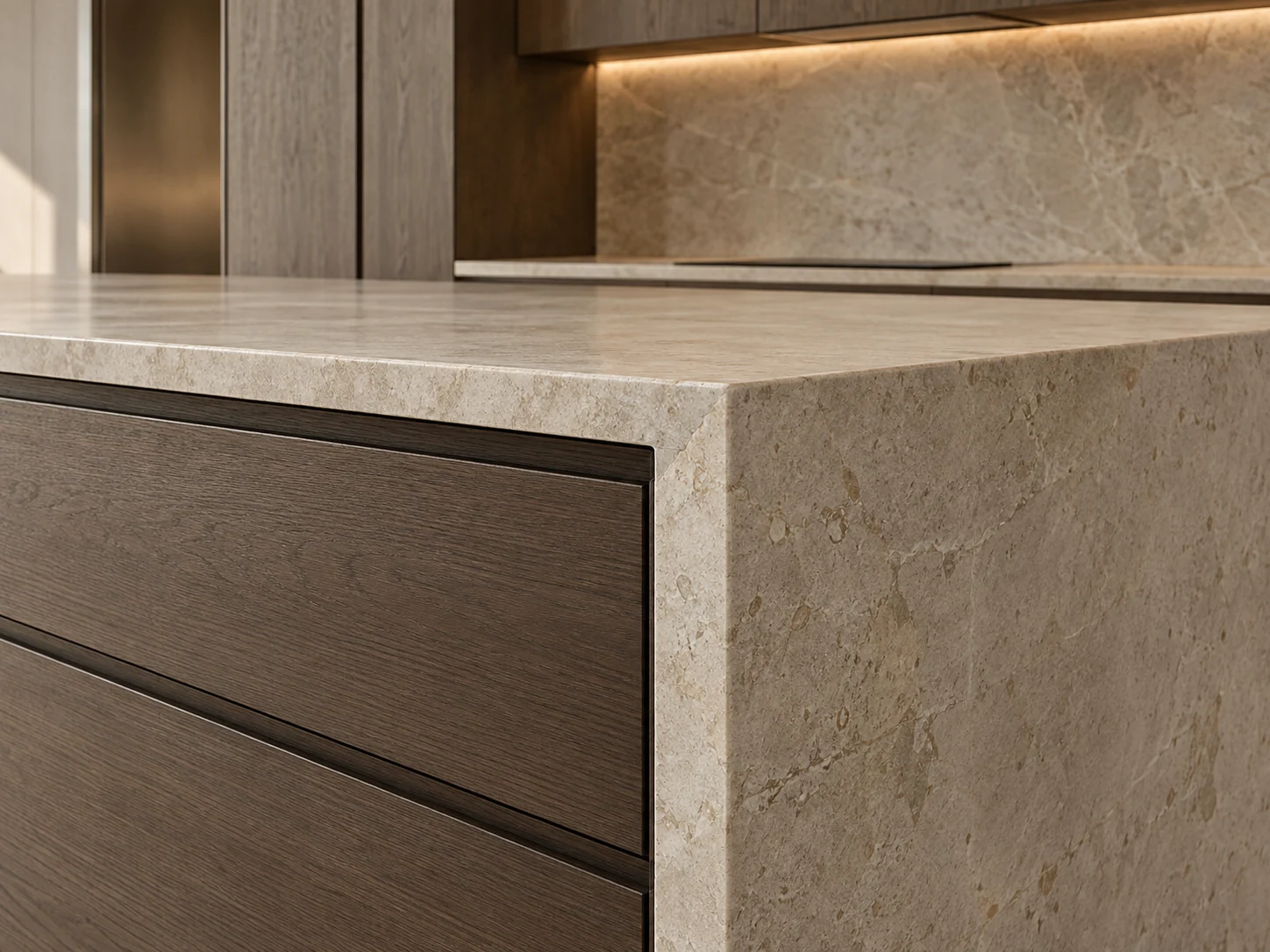 Close view of a limestone waterfall worktop and detailed oak kitchen drawers